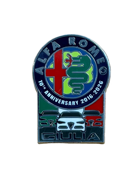 An Alfa Romeo 10th Anniversary enamel lapel pin. The pin features the classic blue, red, and green colors of the Alfa Romeo logo, a green serpent, and a silver Giulia car graphic at the bottom.